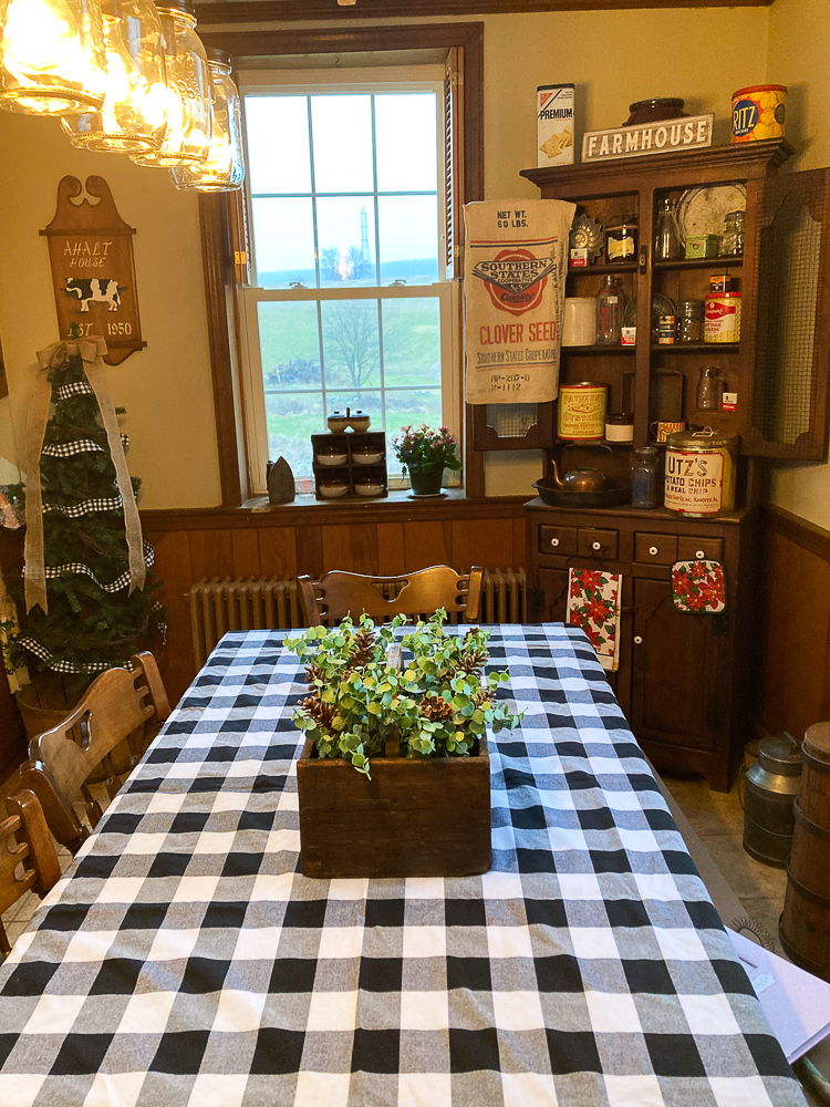 Vintage toolbox decorated with Eucalyptus and pinecones in a farmhouse kitchen.