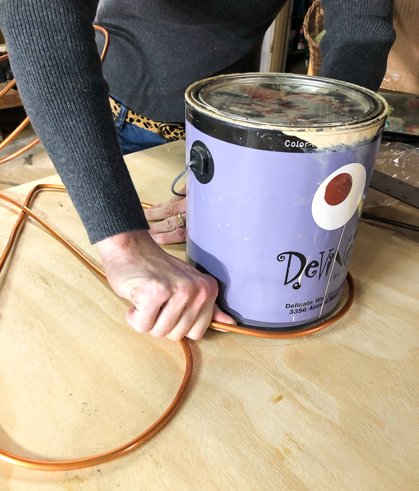 Using a paint can to make the top of a heart with copper tubing