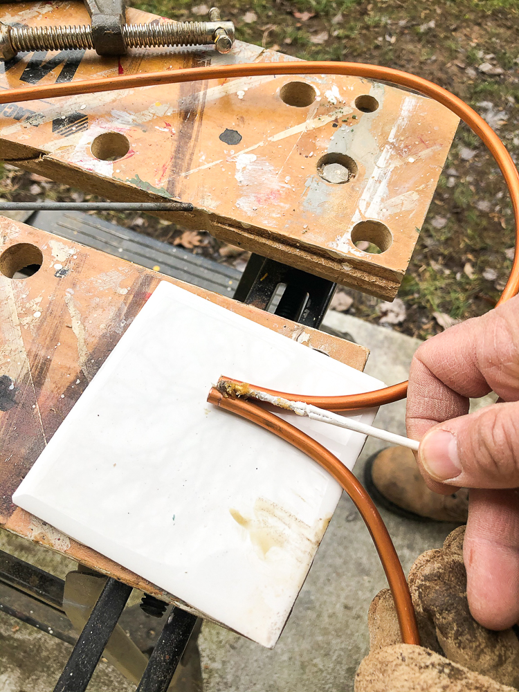 Applying flux to copper pieces