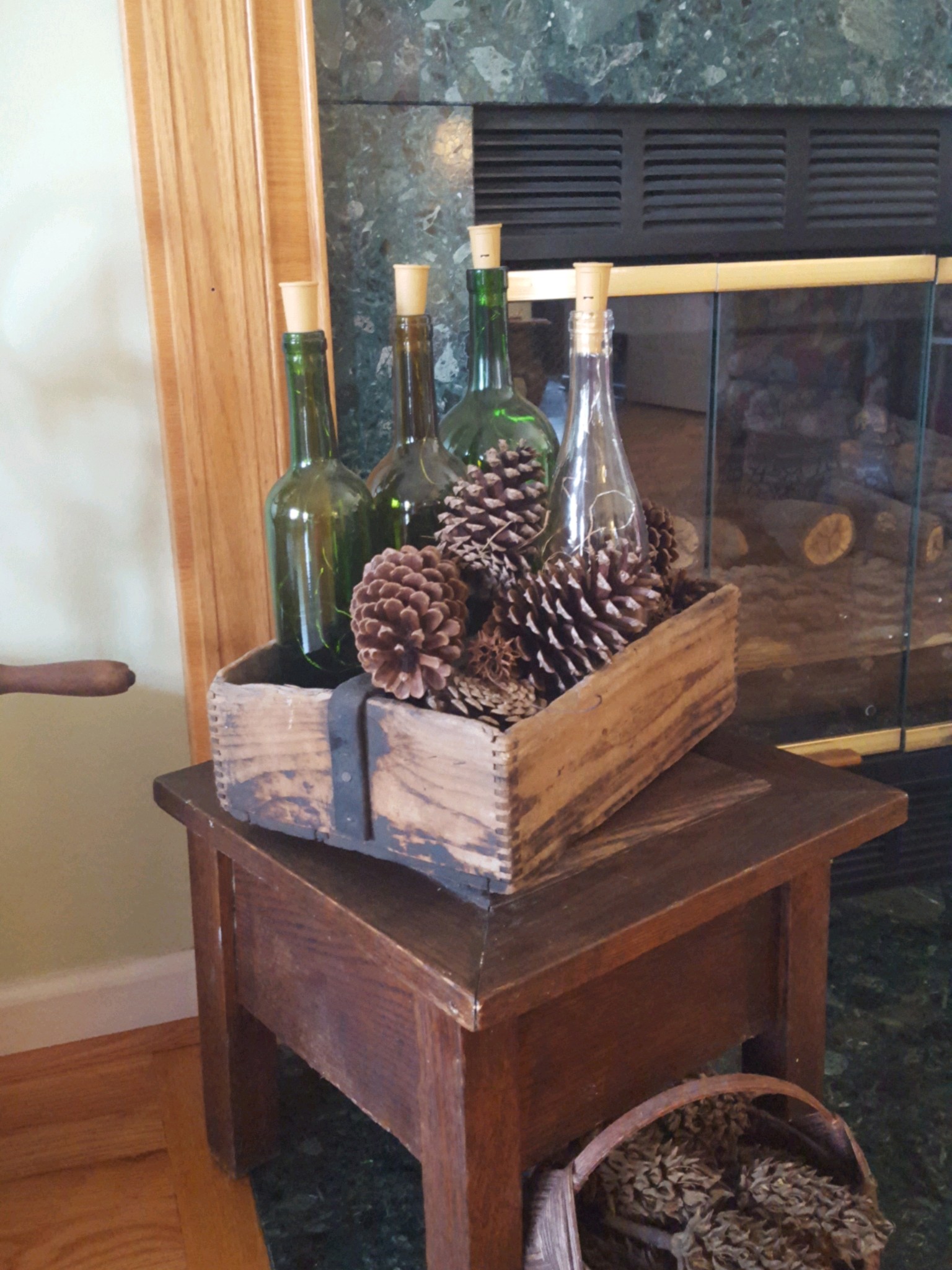 Vintage Toolbox decorated with wine bottles and pinecones