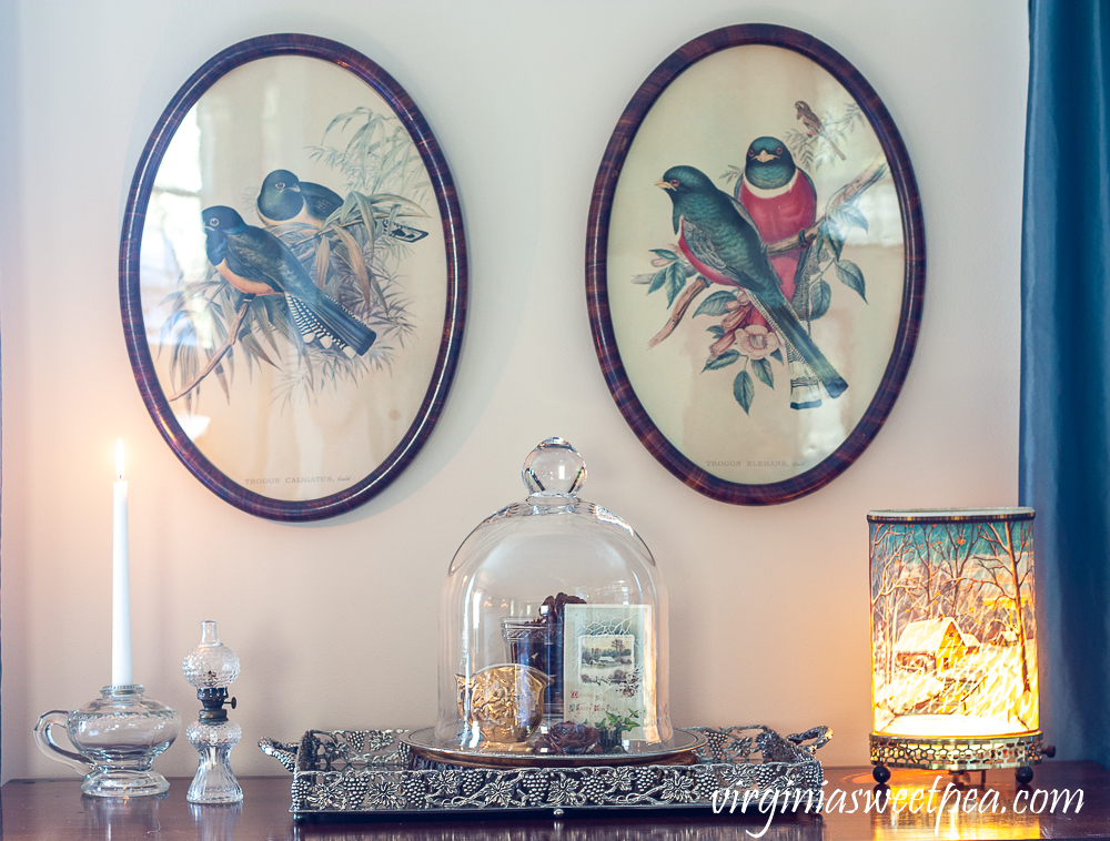 Winter decor using a cloche, Econolite, and antique oil lamps.