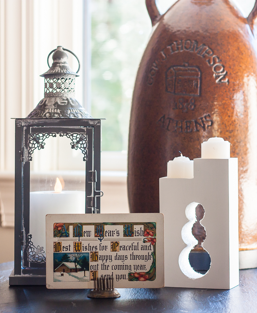 Early 1900s New Year's postcard, gray lantern with a white candle, snowman candle holder.