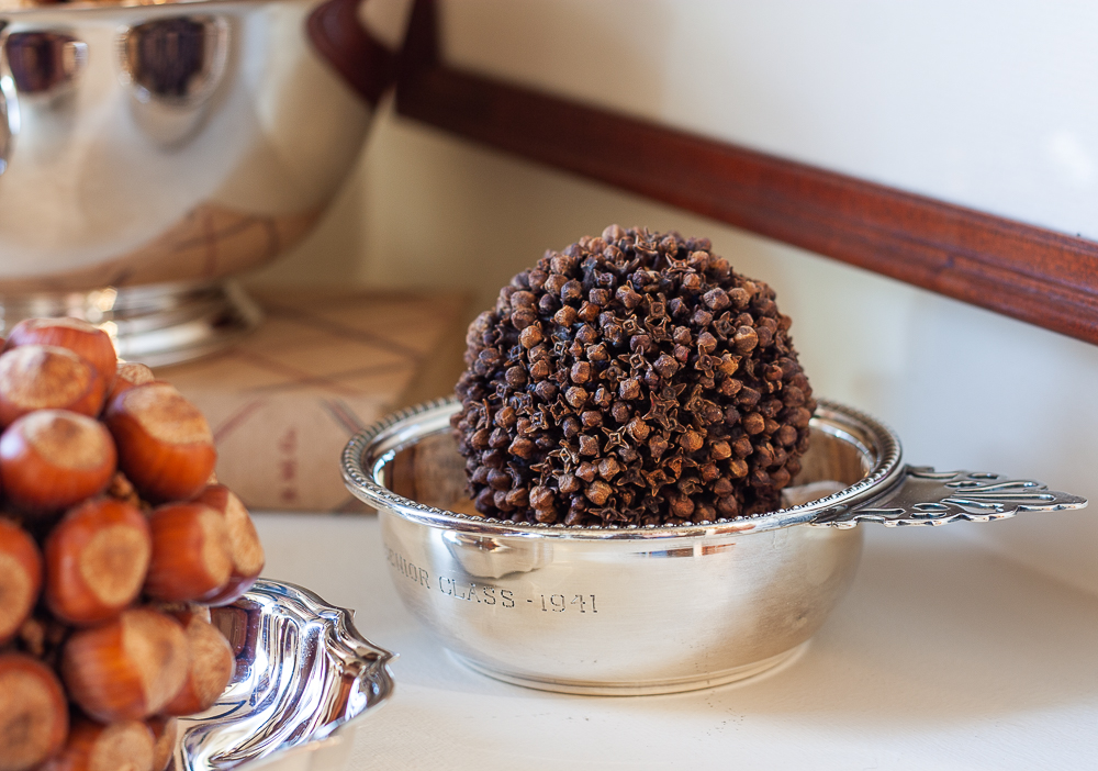 Clove studded orange in a 1941 silver porridge bowl.