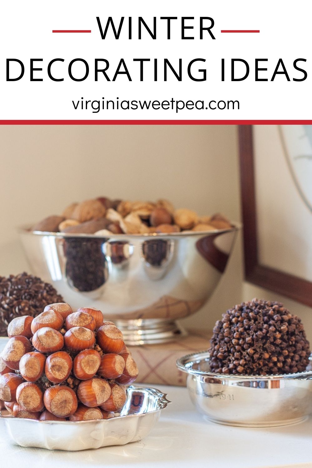 Mixed nuts in their shell in a silver bowl, balls crafted with hemlock cones, hazelnuts, and cloves in silver bowls