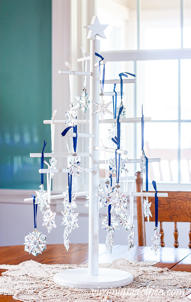 White wood tree on a tabletop decorated with Swarovski crystal snowflakes