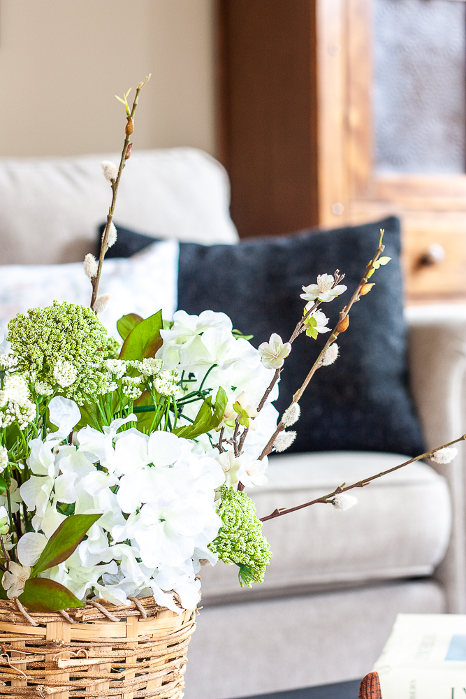 Faux flower arrangement for spring on a coffee table