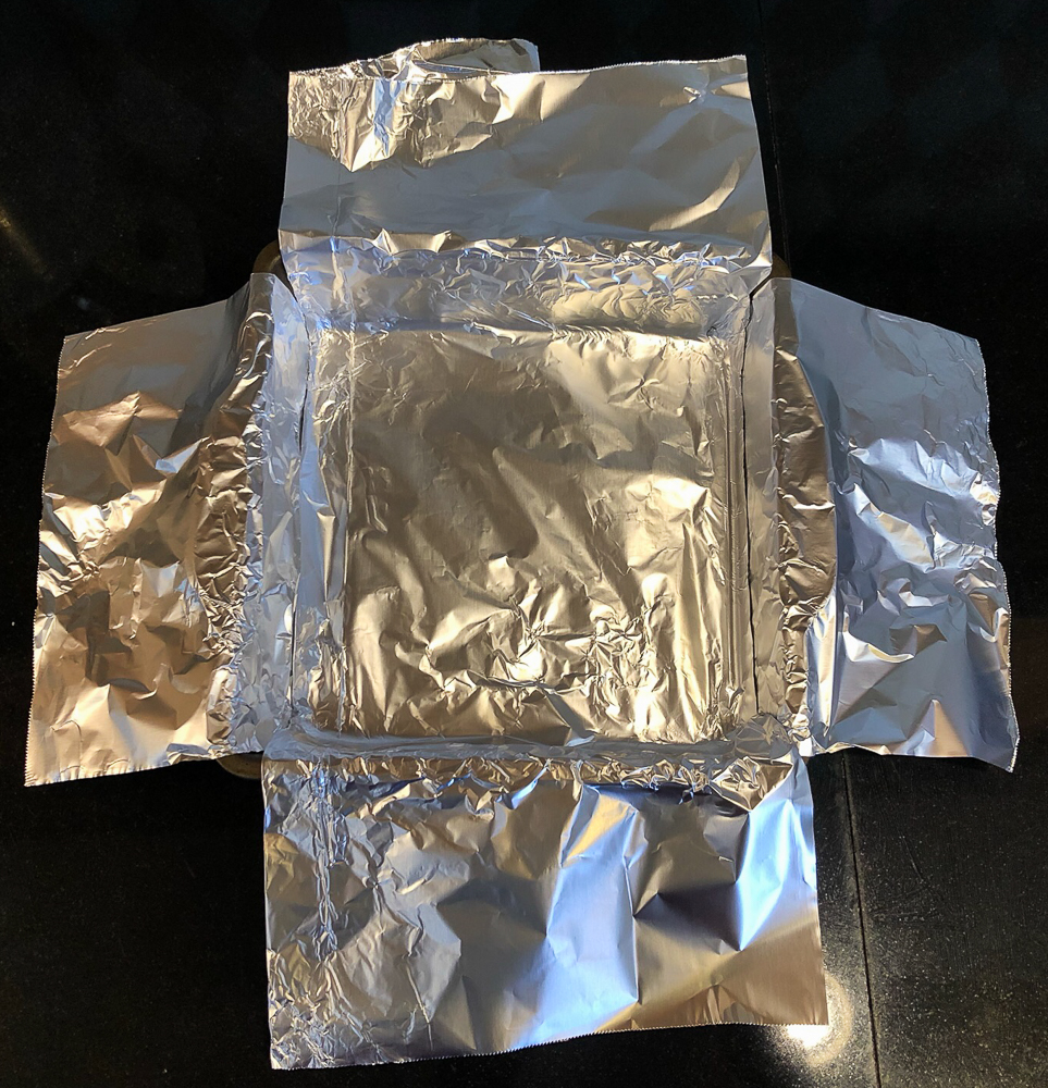 8" x 8" baking pan lines with two sheets of aluminum foil that creates a sling to remove brownies from the pan