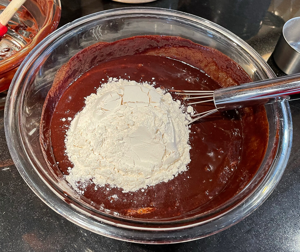 Adding flour to brownie batter