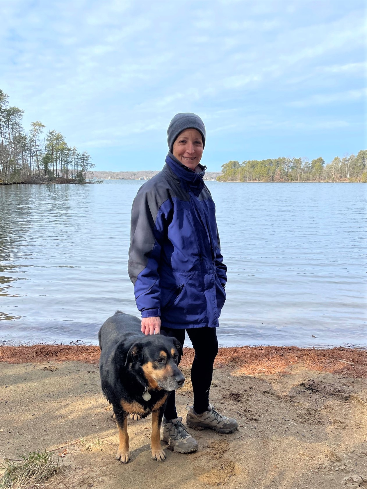 Dog and woman on the shore of Smith Mountain Lake in Virginia