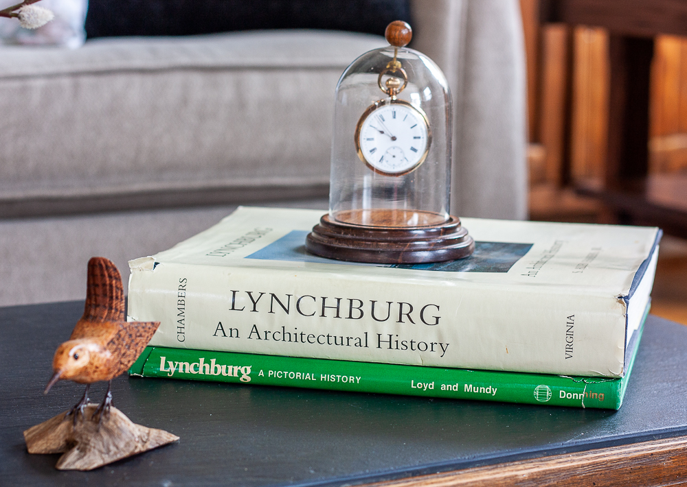 Hand carved bird displayed with S. Allen Chambers Lynchburg an Architectural History book and Lynchburg, A Pictorial History Book and an antique pocket watch