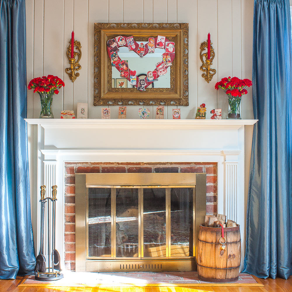 Mantel decorated for Valentine's Day with vintage Valentine's Day cards
