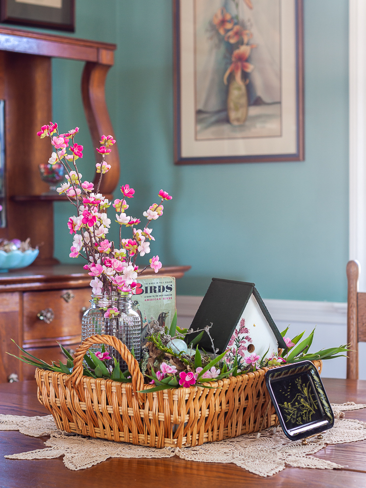 Handmade bird house with a 1949 Birds Golden Nature Guide and pink flowers in a clear, embossed Mason Jar