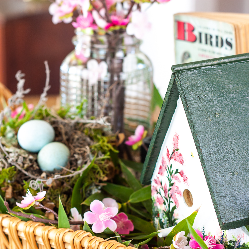 Handmade bird house with a 1949 Birds Golden Nature Guide and pink flowers in a clear, embossed Mason Jar