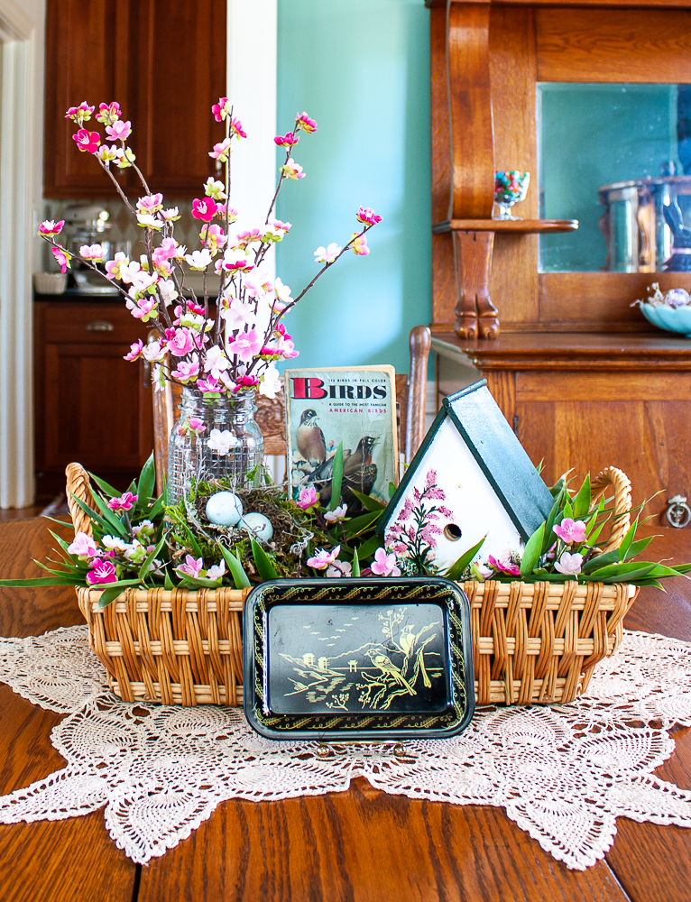 Handmade bird house with a 1949 Birds Golden Nature Guide and pink flowers in a clear, embossed Mason Jar