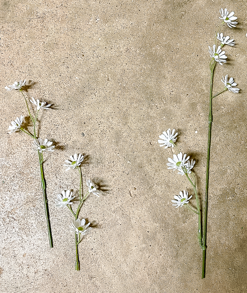 Faux stems of florals that look like daisies