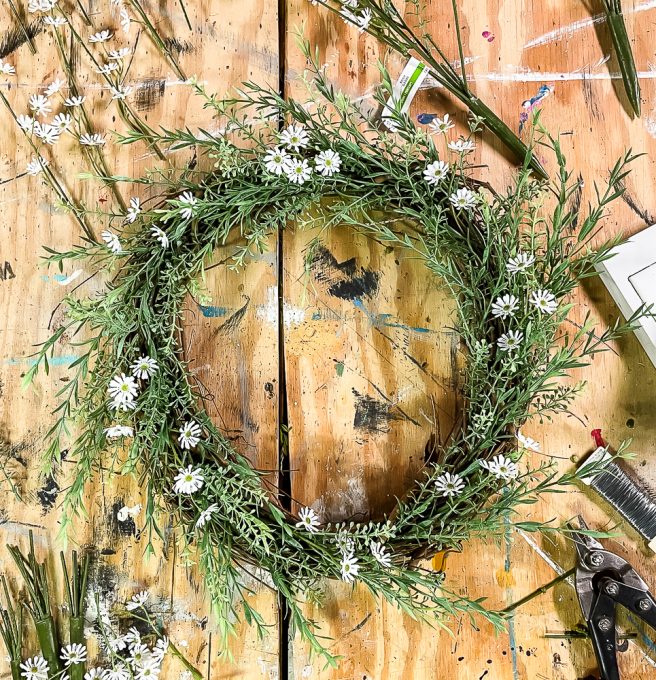 Daisies and greenery on a grapevine wreath