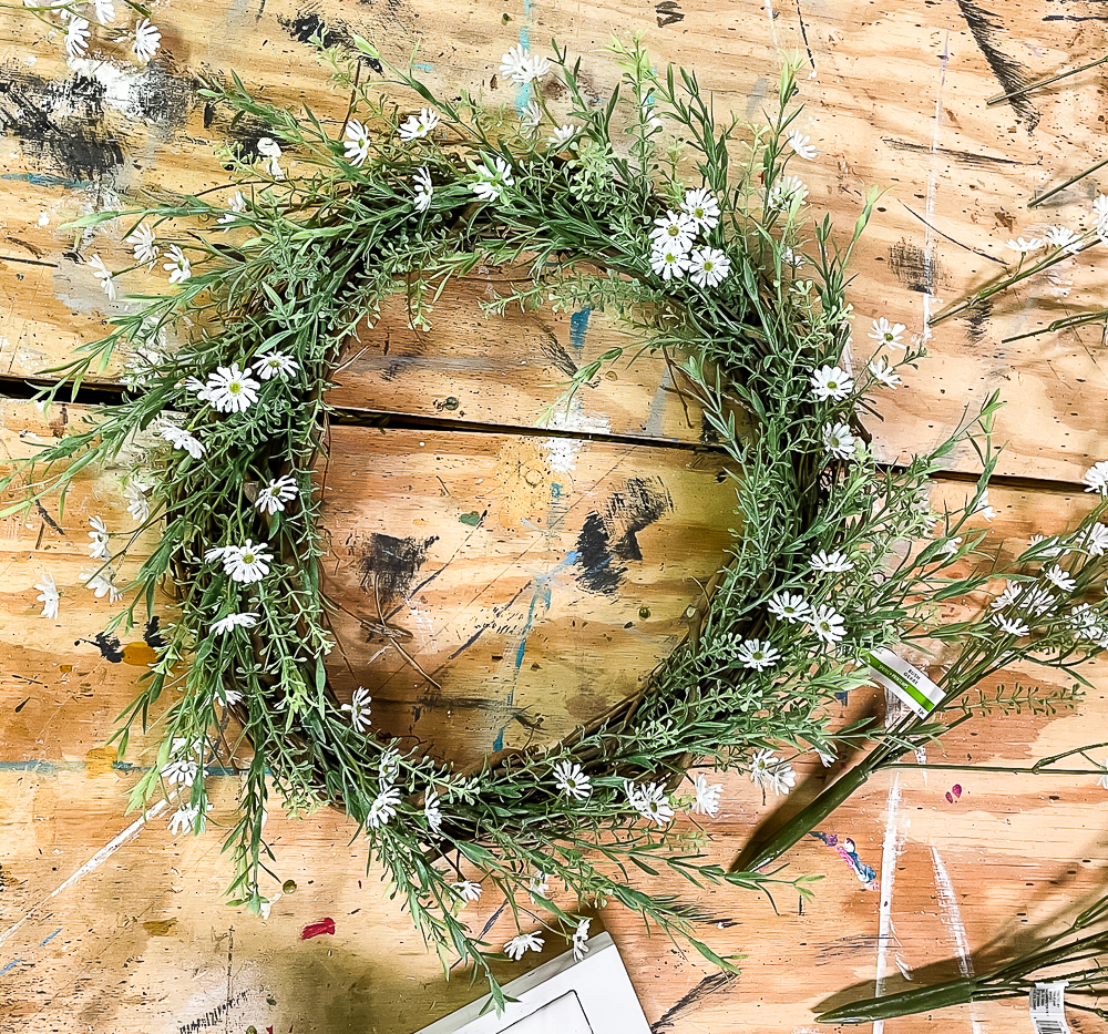 Daisies and greenery on a grapevine wreath