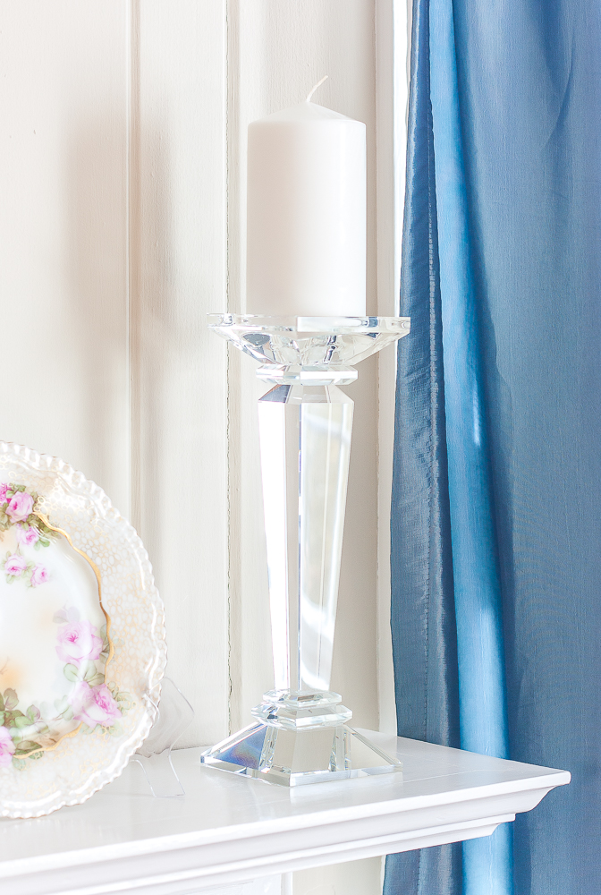 Lamps Plus crystal candle holders with a white candle on a decorated for spring mantel