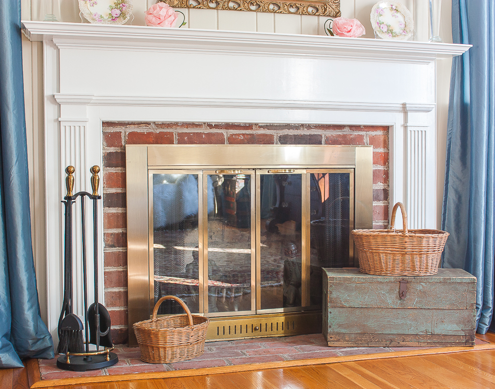 Fireplace hearth decorated with a vintage toolbox and baskets made by Charles M. Phleeger of Middletown, Maryland