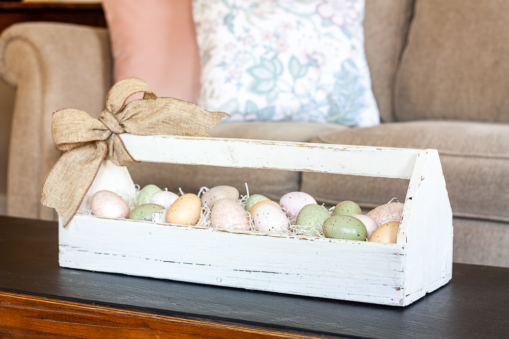 Pink, green brown speckled eggs displayed in a vintage toolbox