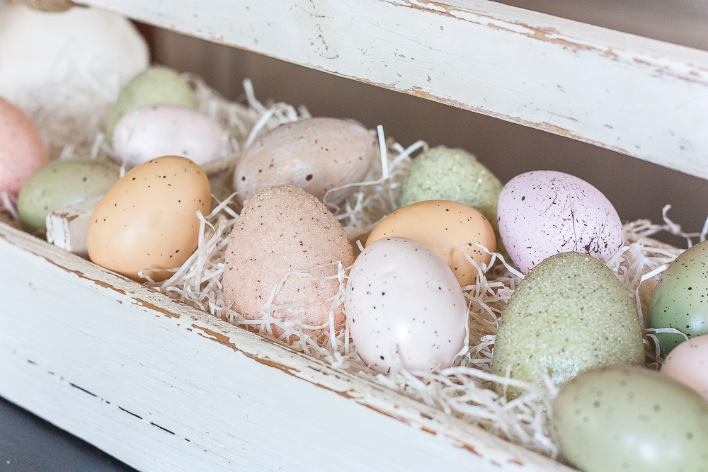 Pink, green brown speckled eggs displayed in a vintage toolbox