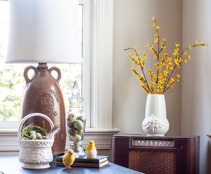 Forsythia in a white pottery vase, Hull USA basket pottery filled with a nest, chicks, eggs in a vintage glass lidded candy jar