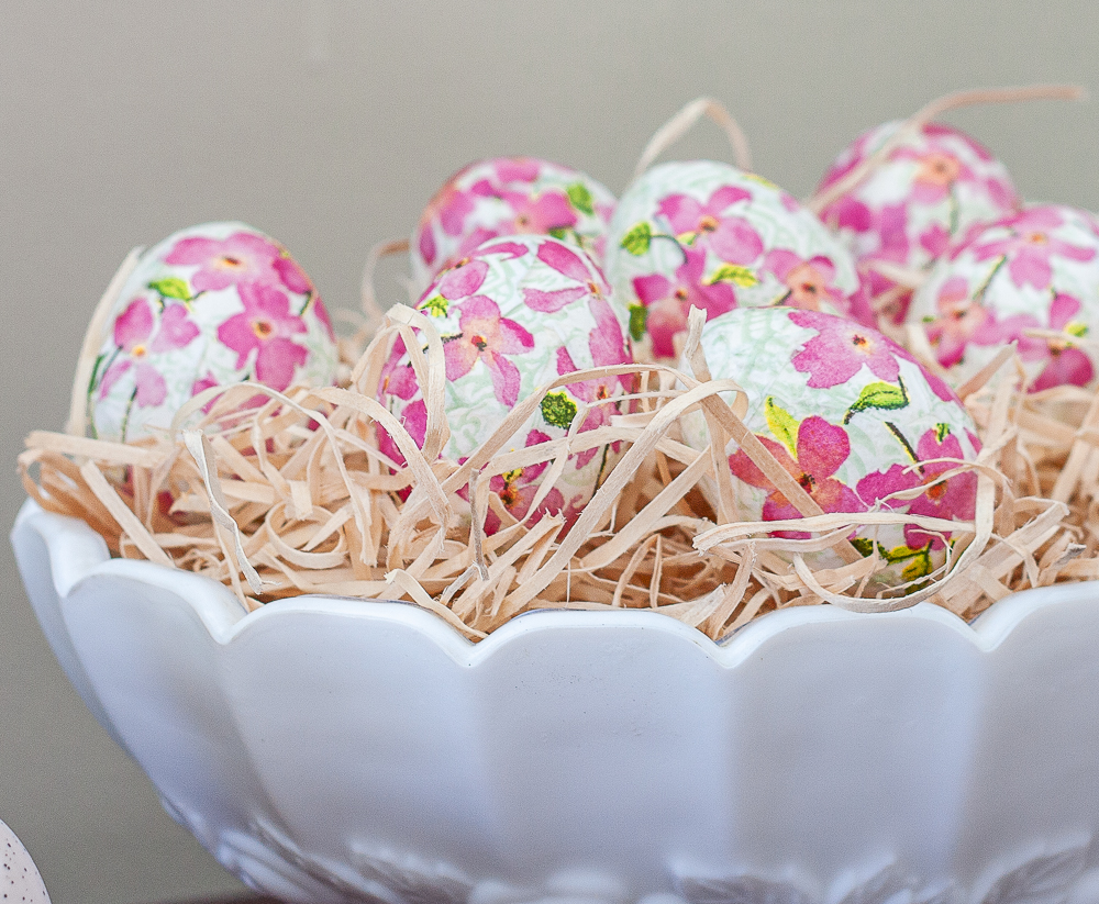 Decoupaged Easter eggs displayed in a milk glass fruit bowl