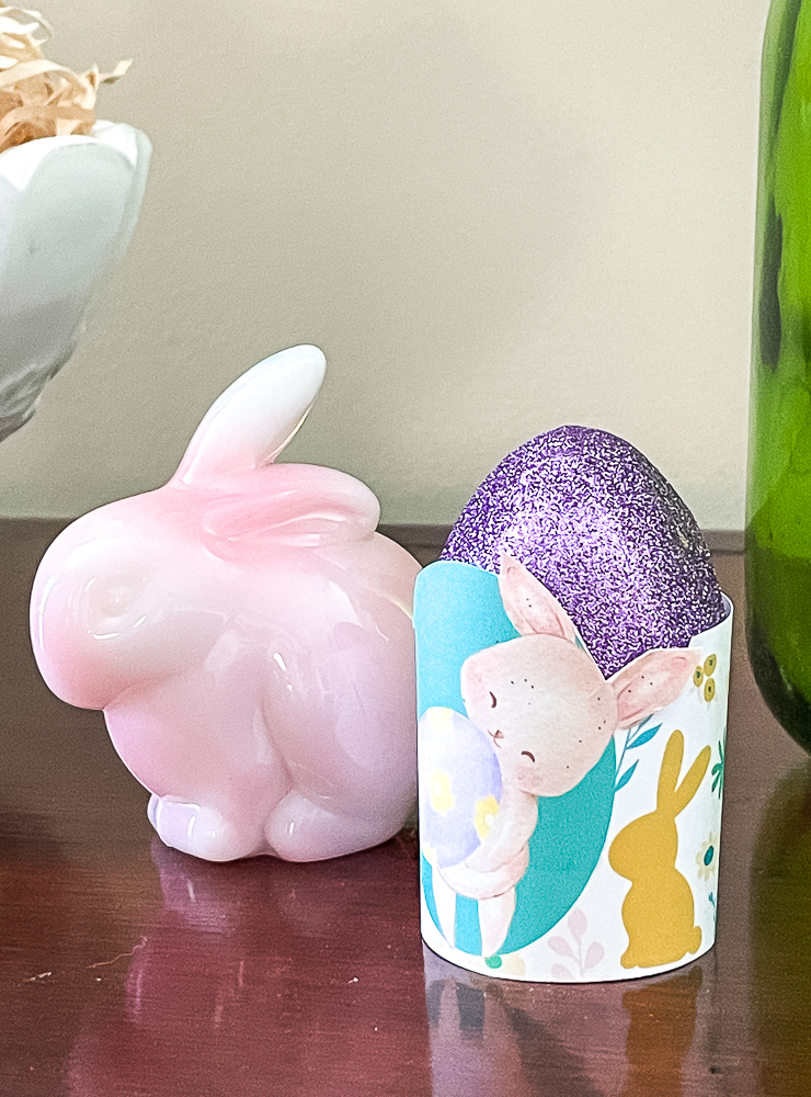 pink fenton rabbit with paper easter egg holder and a purple glittered egg