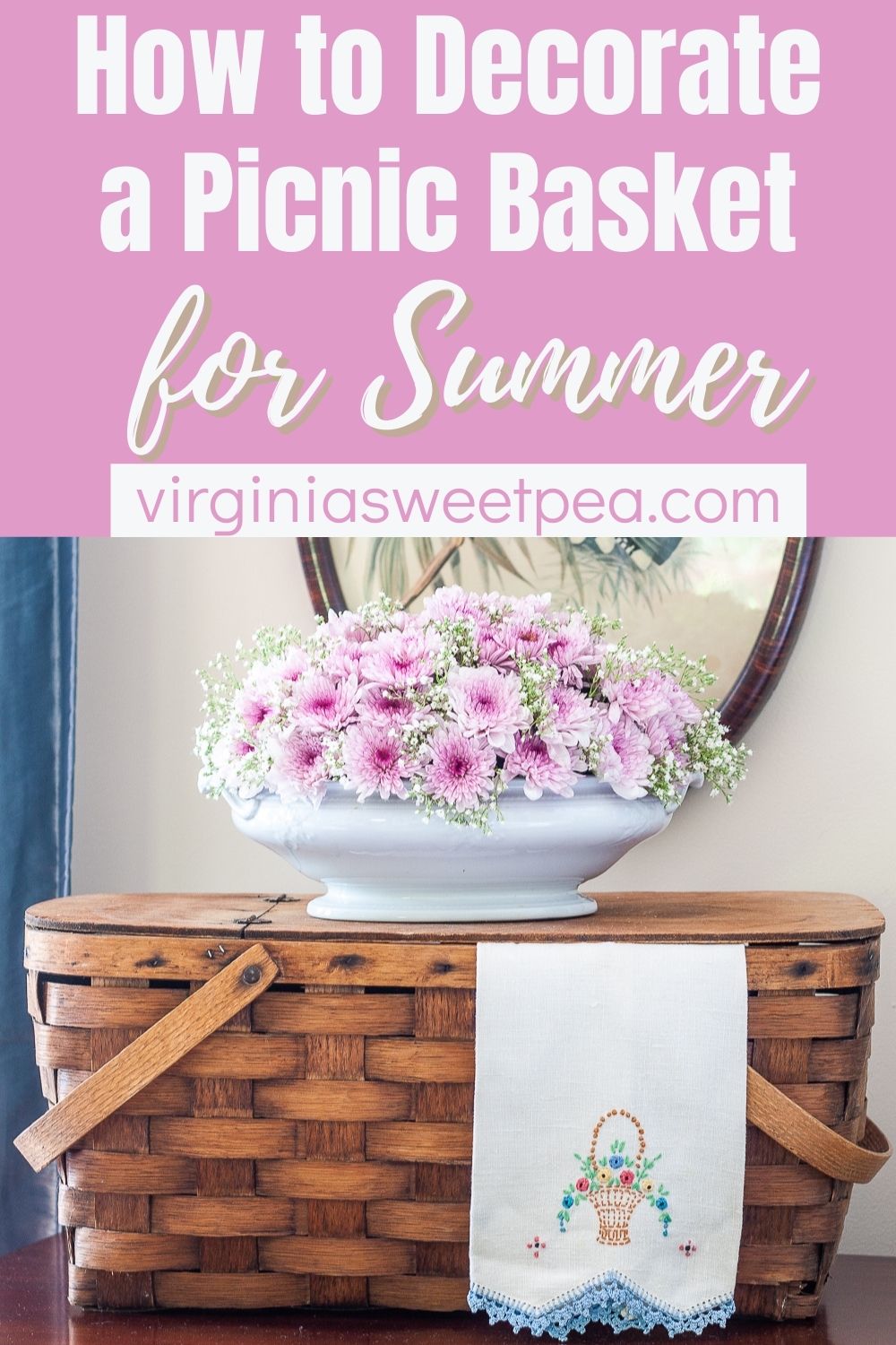 Vintage picnic basket with a floral arrangement, and vintage embroidered tea towel