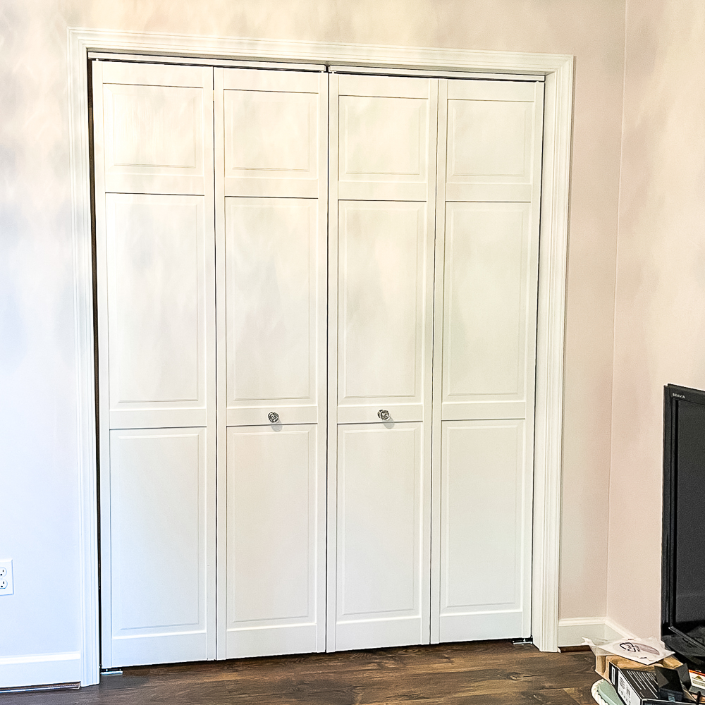 Bifold closet doors painted white with glass look knobs