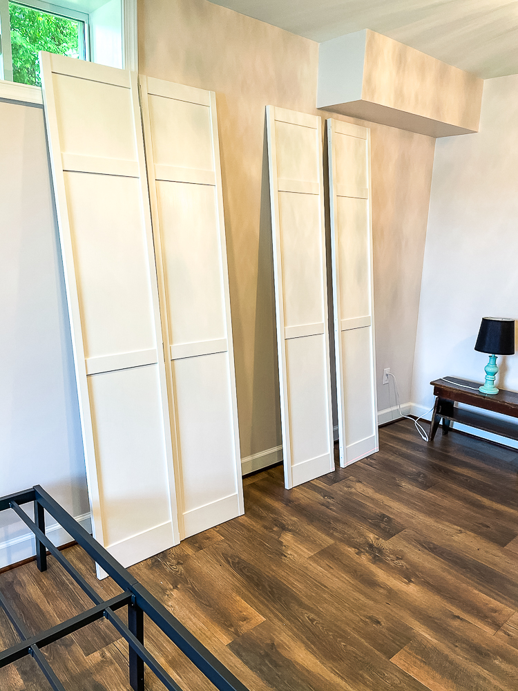 Four painted white bifold closet doors