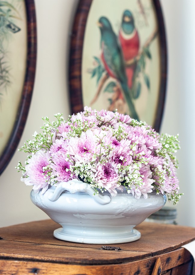 Light purple Chrysanthemums and Baby's Breath floral arrangement in an Ironstone bowl