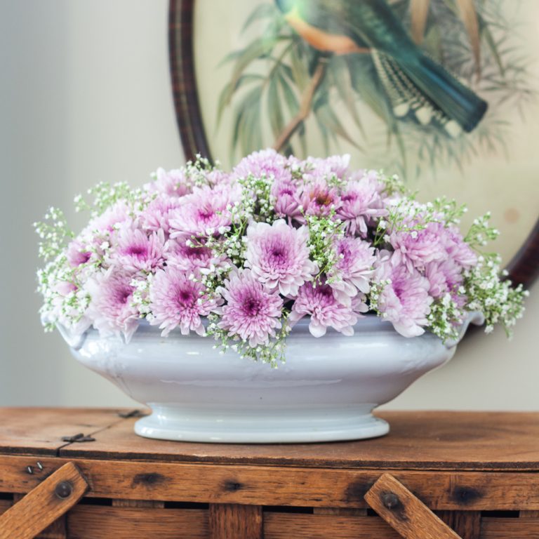 Light purple Chrysanthemums and Baby's Breath floral arrangement in an Ironstone bowl