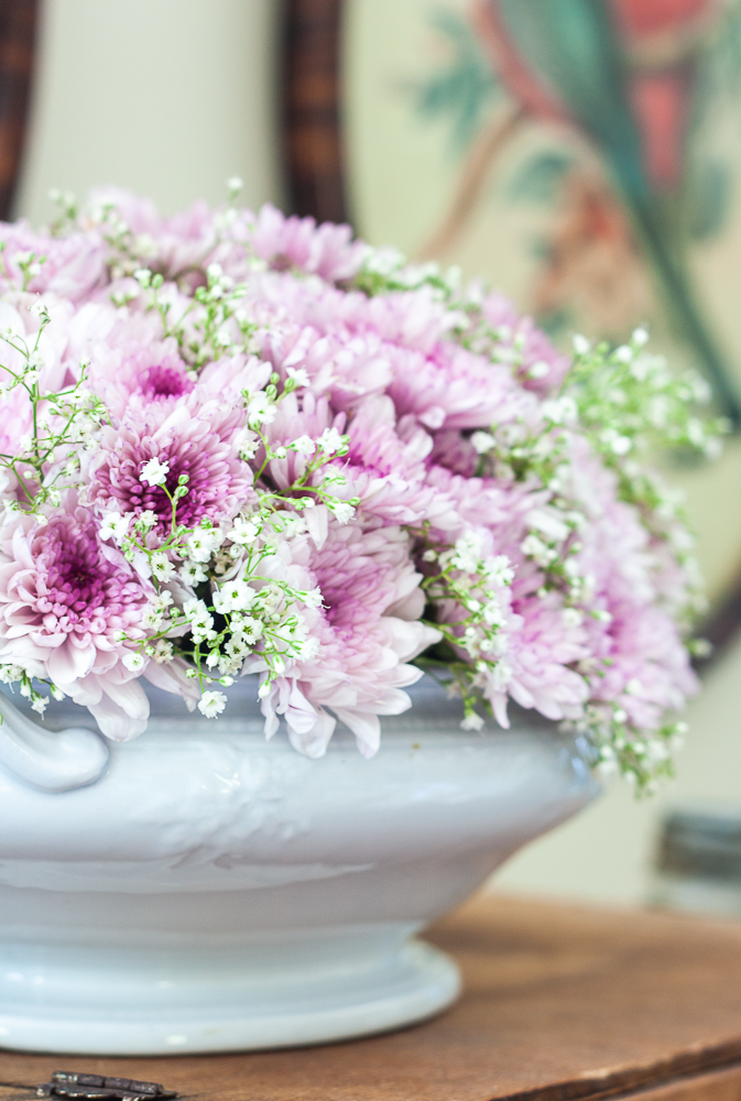 Purple Chrysanthemums and Baby's Breath floral arrangement in an Ironstone bowl