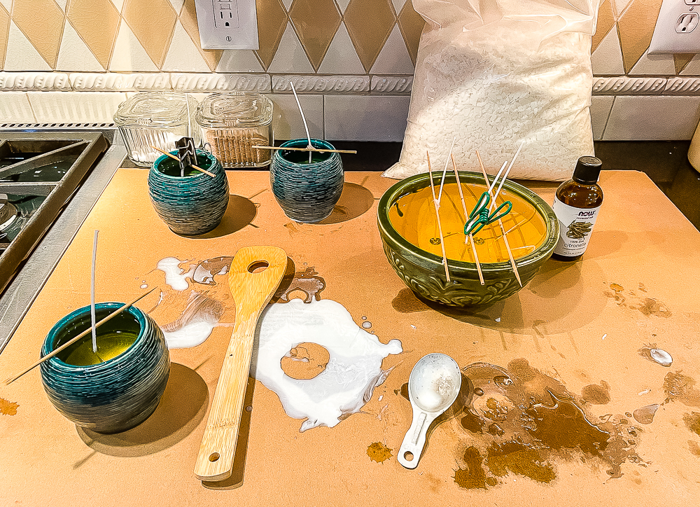 Making homemade Citronella candles - wax poured into the containers