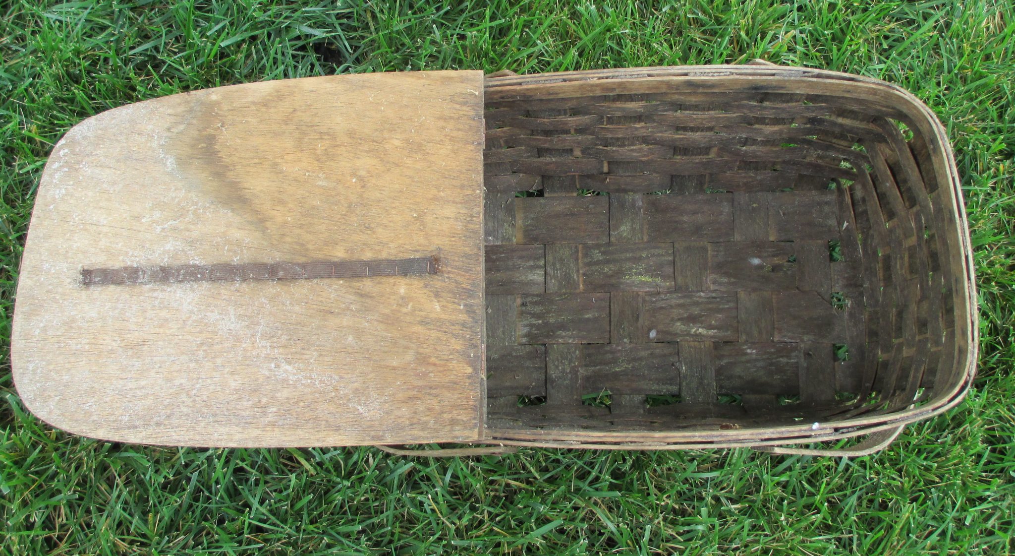 Dirty inside of a picnic basket found in a trash pile