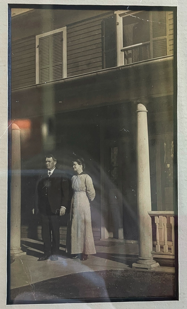 Couple standing on the porch of their newly build 1912 home in Waynesboro, VA on Walnut Avenue