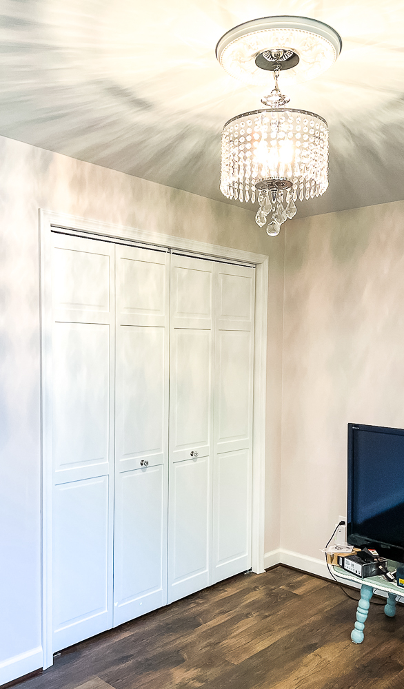 Bifold closet doors painted white with glass look knobs