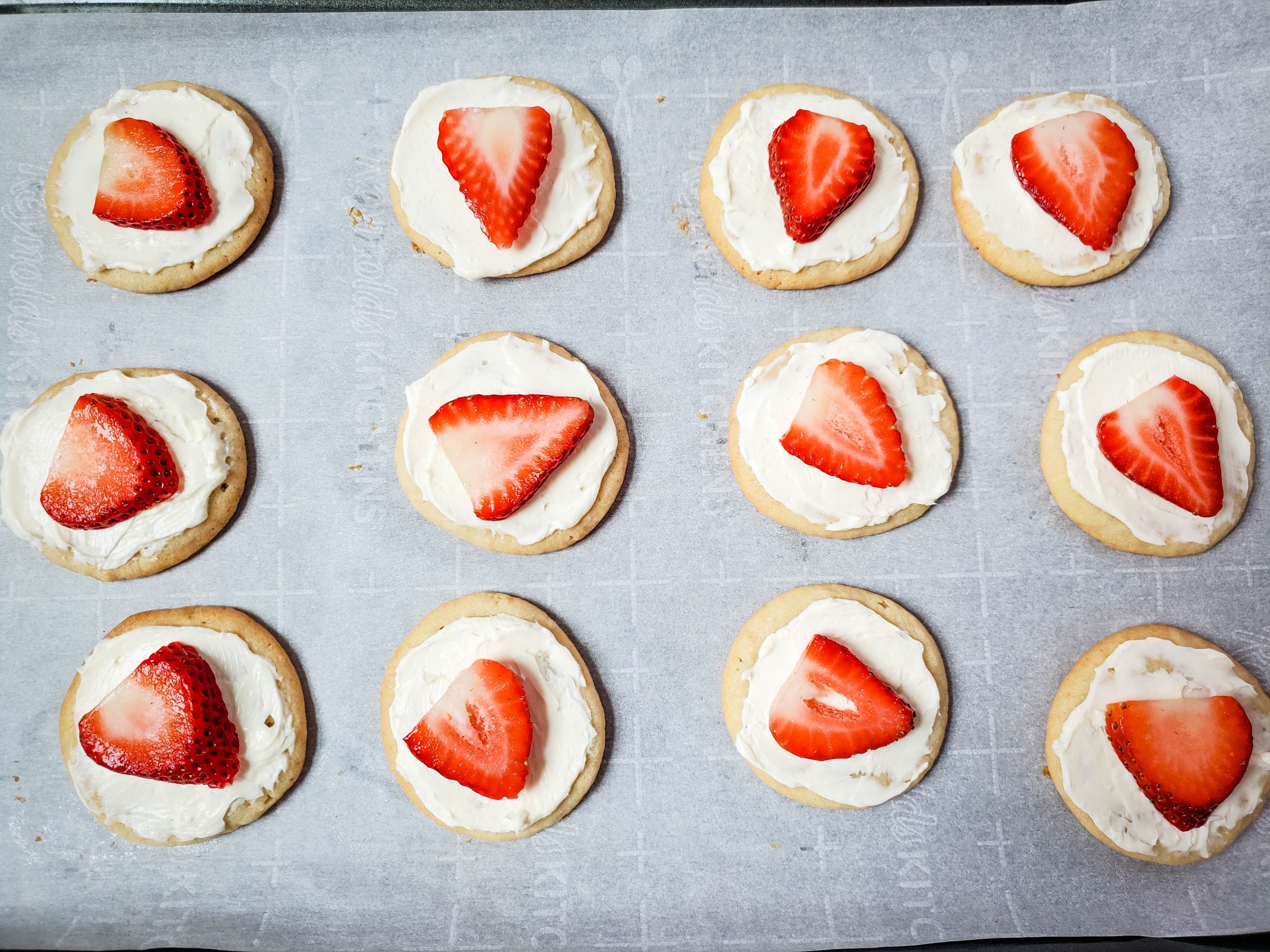 Sugar Cookies Iced with Cream Cheese Frosting and Toped with a Strawberry Slice