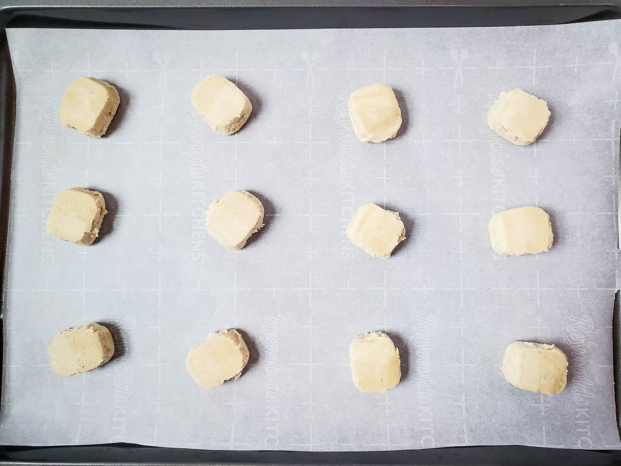 Sugar cookie balls on a baking sheet