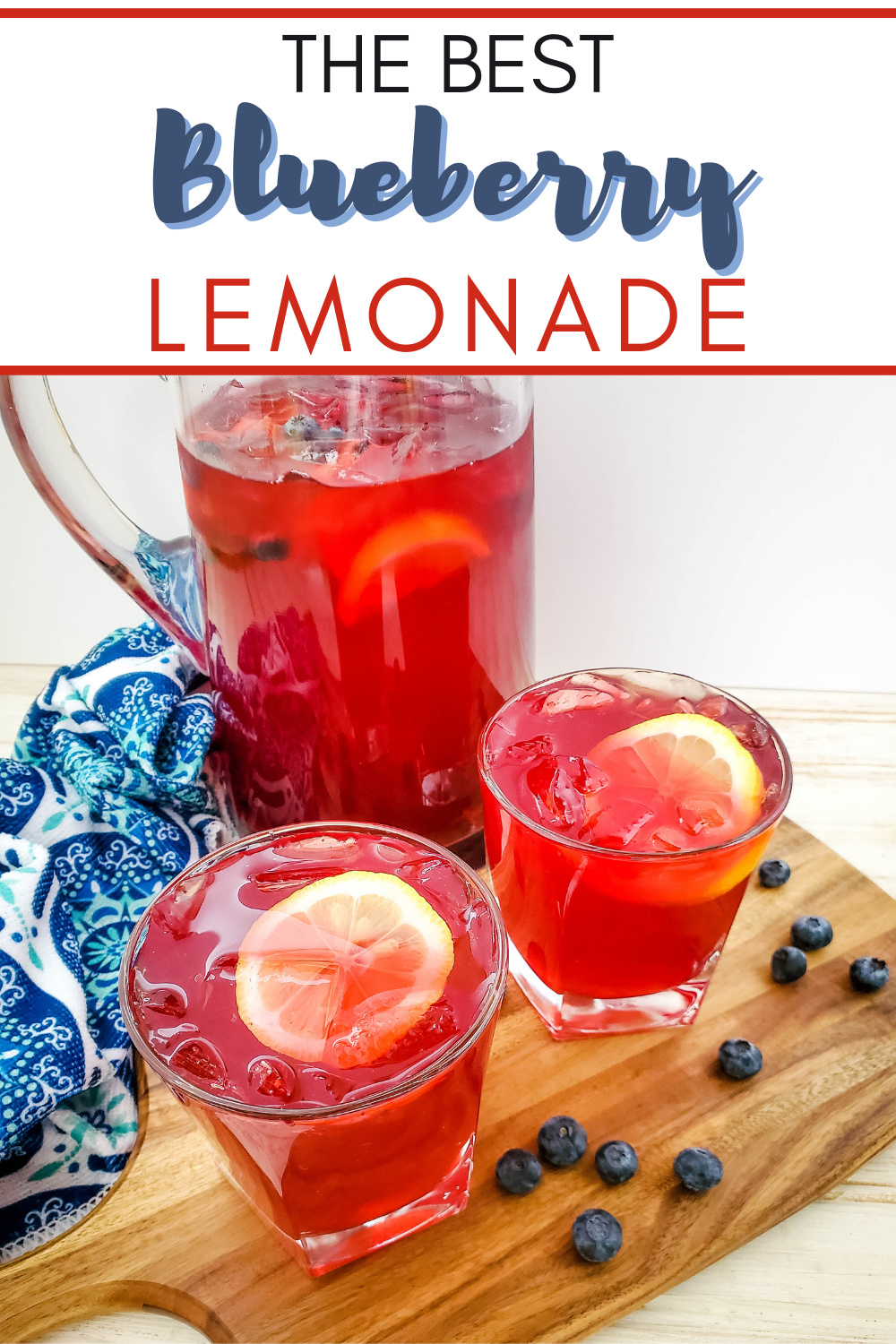 Homemade blueberry lemonade served in a pitcher with two poured glasses garnished with a lemon slice and blueberries