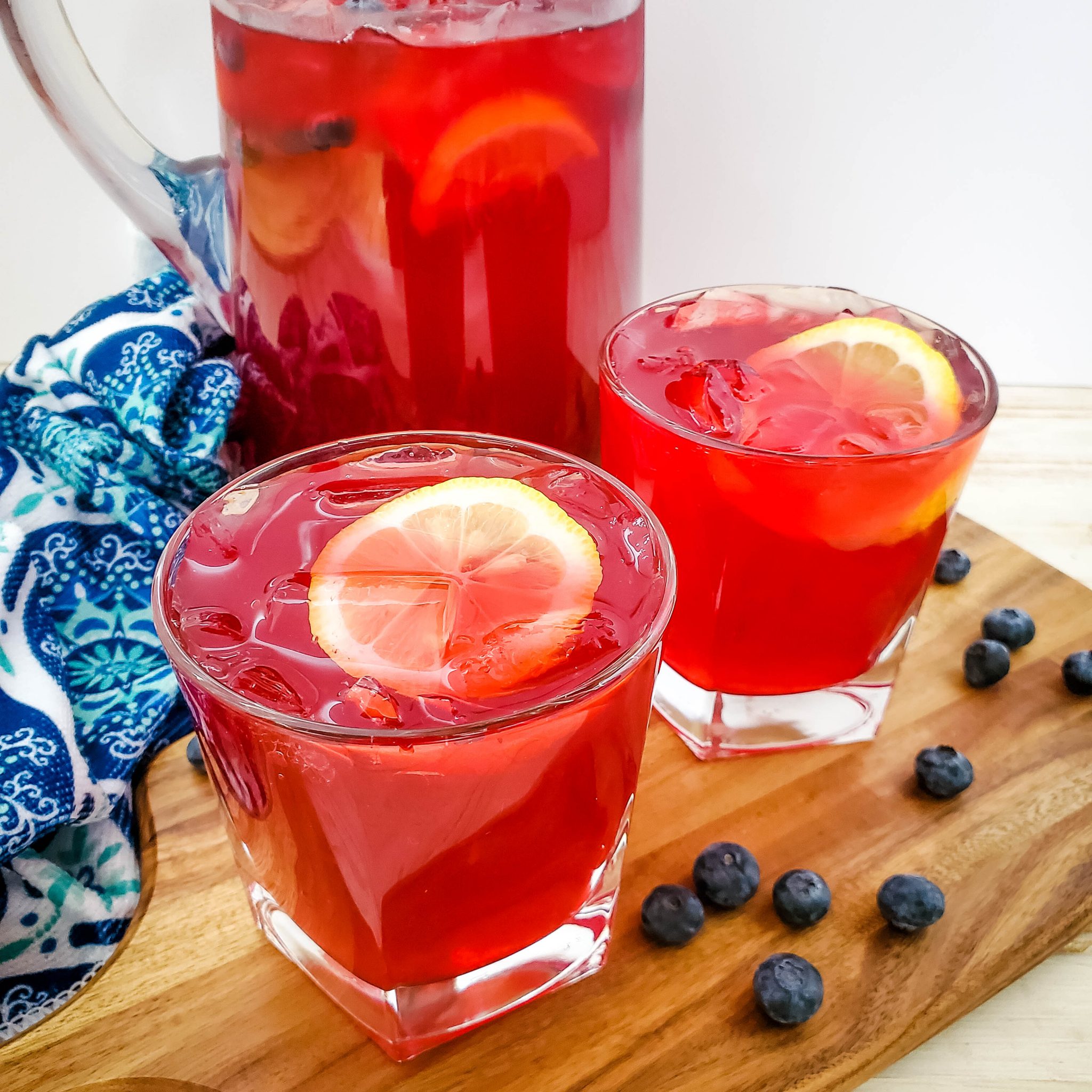 Homemade blueberry lemonade served in glasses garnished with lemons and blueberries