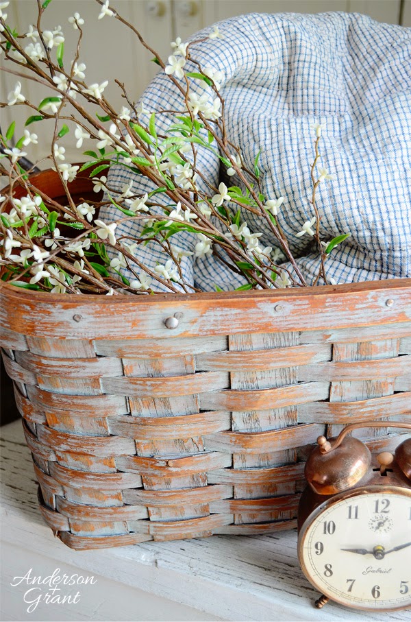 Picnic basket with floral branches, plaid fabric and a clock