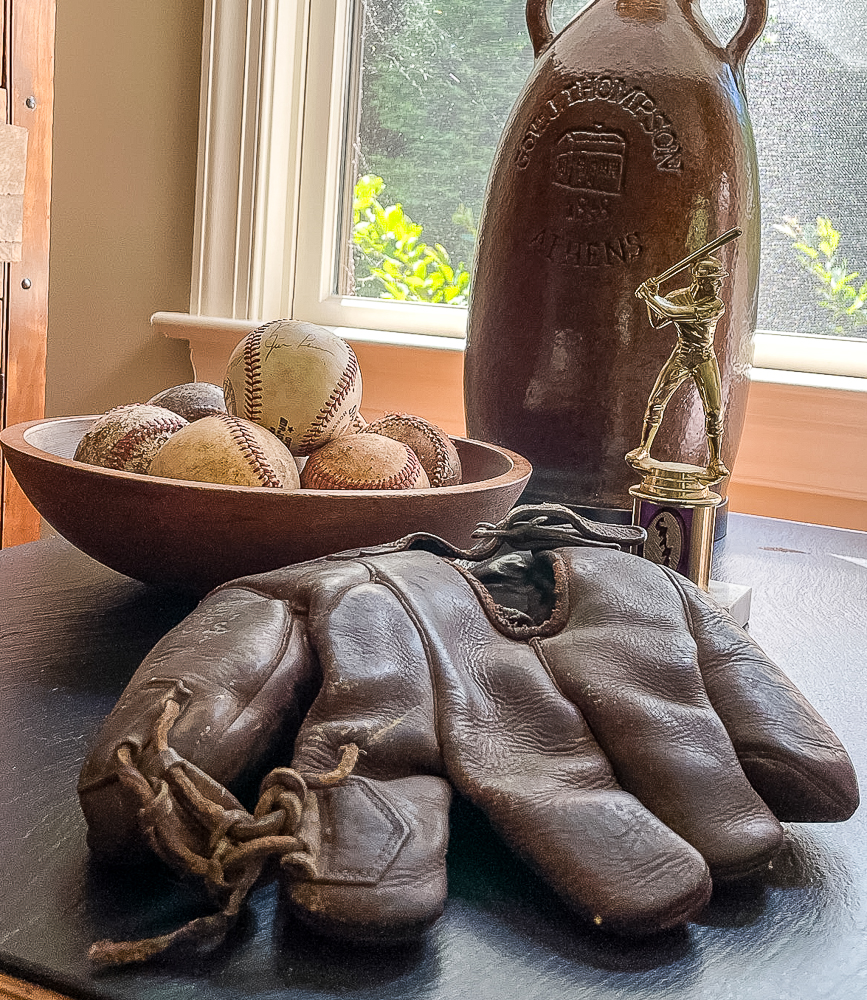 1920’S GOLDSMITH BASEBALL GLOVE, 1970s baseball trophy, and bowl of baseballs