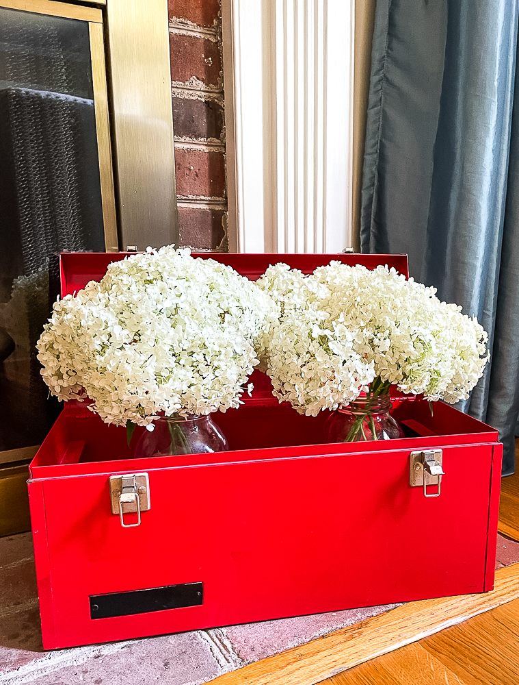 red toolbox filled with hydrangea