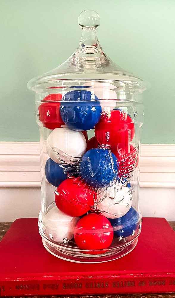 painted ping pong balls in a glass jar