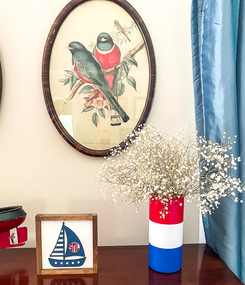 Framed sailboat and red, white and blue vase with Baby's Breath