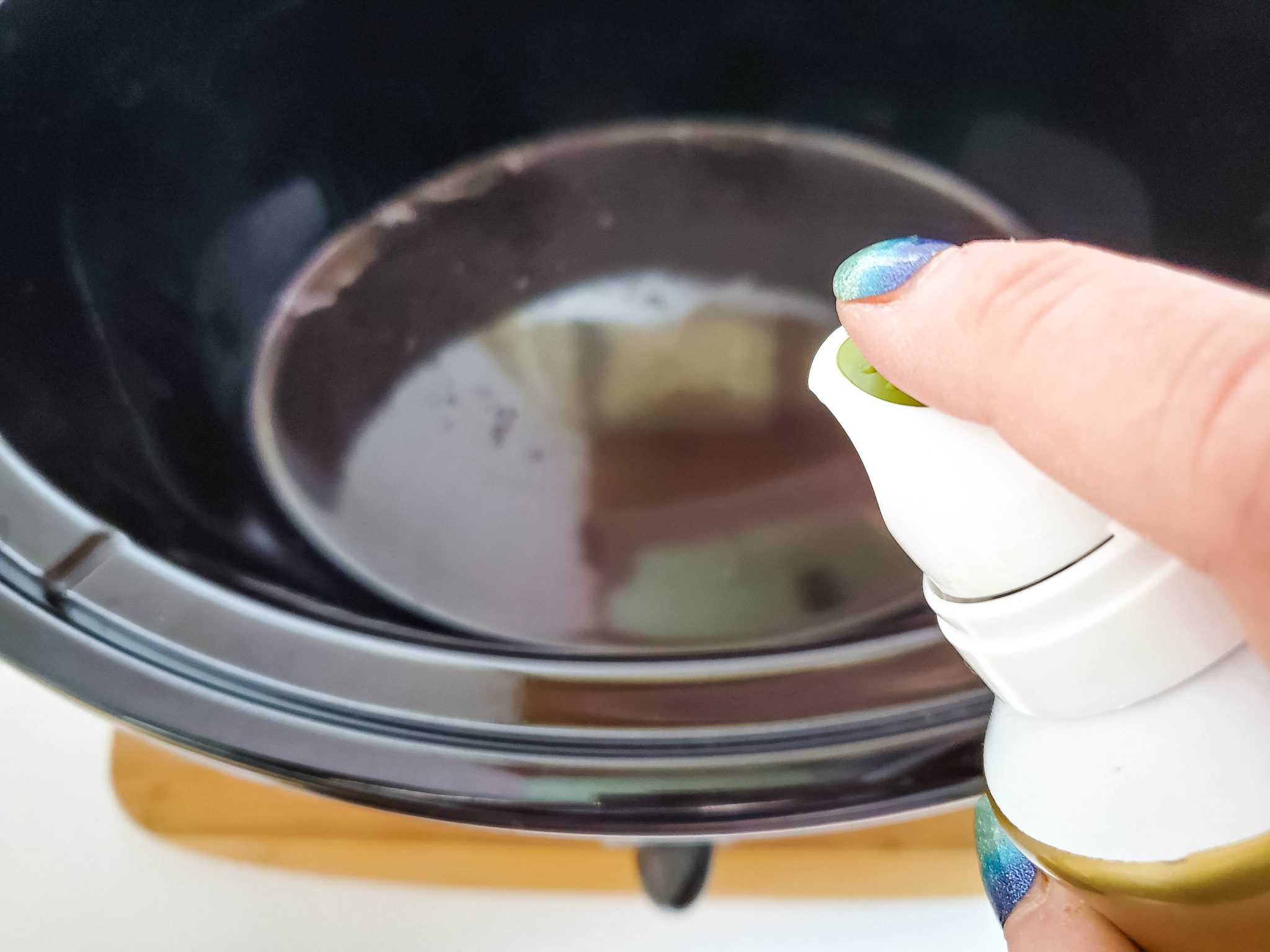 Spraying a Crockpot with Cooking Spray