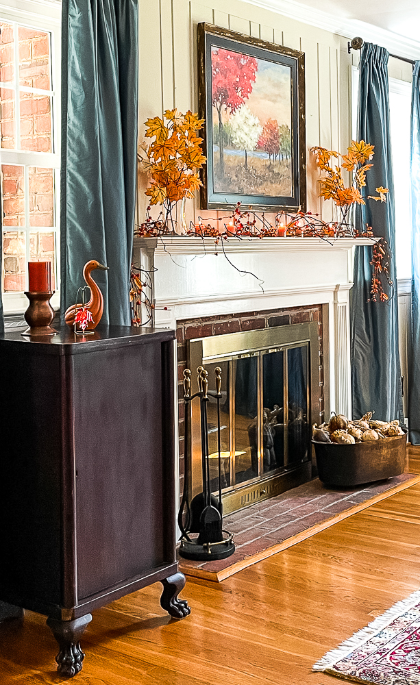 Fall mantel decorated in traditional fall colors