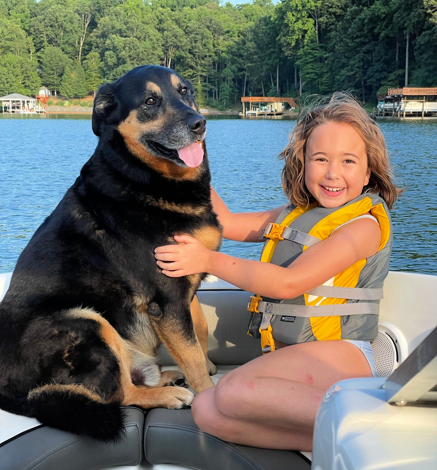 Child and dog on a boat at Smith Mountain Lake, VA